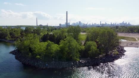 flying around the coastline of a busy beach outside of toronto on lake ontario