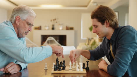 two men playing chess at home