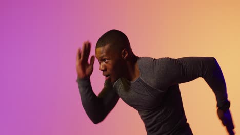 African-american-male-runner-with-sportswear-over-pink-lighting