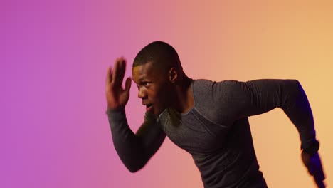 african american male runner with sportswear over pink lighting