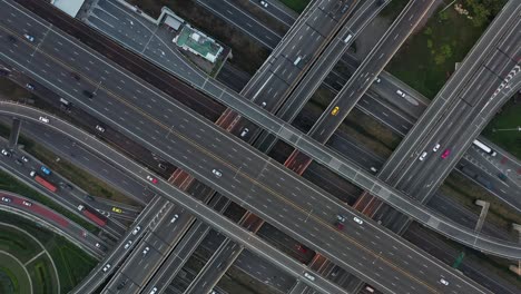 high angle looking top down view of complicate road and expressway intersection in bangkok city of thailand. shot by drone can use for transportation or abstract concept.