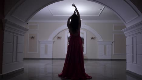 woman in red gown in elegant hallway