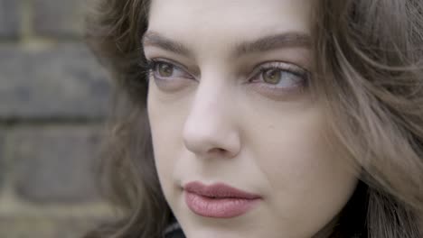 Medium-close-up-portrait-of-beautiful-woman-looking-straight-in-central-London-street