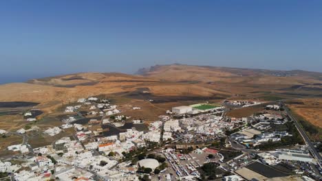 beautiful white color town in lanzarote island, high altitude aerial view