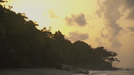 Timelpase-of-the-sun-setting-behind-the-mountain-with-a-shipwreck-in-the-foreground