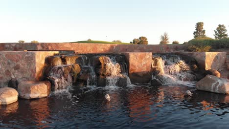 drone footage from a golf course near a residential neighborhood in arizona. close up shot of the feature in a water hazard