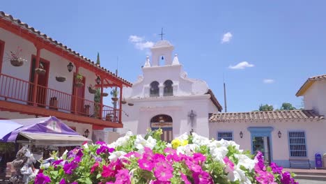 beautiful revealing 4k shot of flowers and church in pueblito paisa, medellin