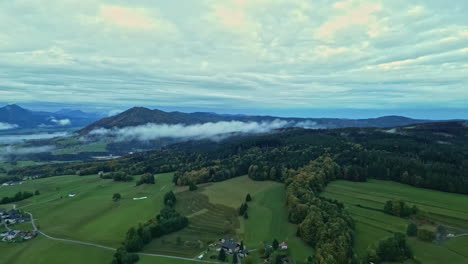 Lush-Forest-And-Sloping-Mountains-Under-Cloudscape-Sky