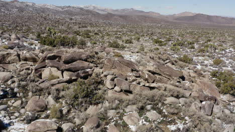 drone view of a rocky area with snow in the joshua tree national park