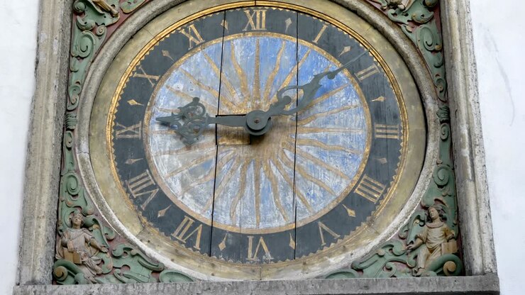 The wooden clock on the wall in the city