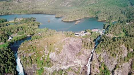 Crane-up-drone-shot-over-two-large-waterfalls-in-Norway-with-lake-Lotevatnet-in-the-background-part-2