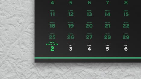 primer plano de una hermosa página de calendario de pared negra con un horario de los días de ayuno de ramadán 2022 y la cámara se mueve a la fecha de eid al-fitr marcada en verde