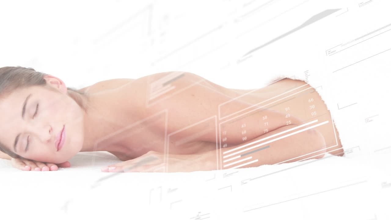 Female model reclining on treatment bed opening eyes as digital panels updating wellness data