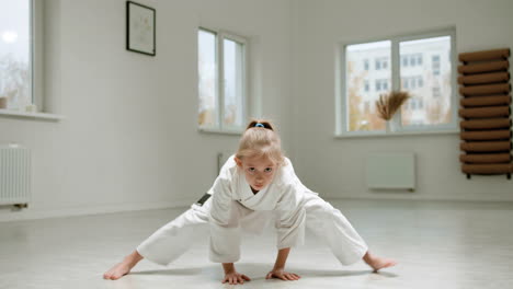 girl in white kimono in martial arts class