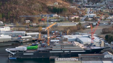 Drone-clip-showing-the-entire-long-side-of-the-research-vessel-"REV-Ocean"-docked-at-VARD-shipyards-in-Søvik,-Norway