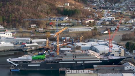 drone clip showing the entire long side of the research vessel "rev ocean" docked at vard shipyards in søvik, norway