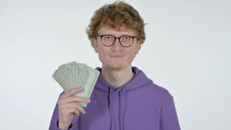 redhead young man counting dollars, white background