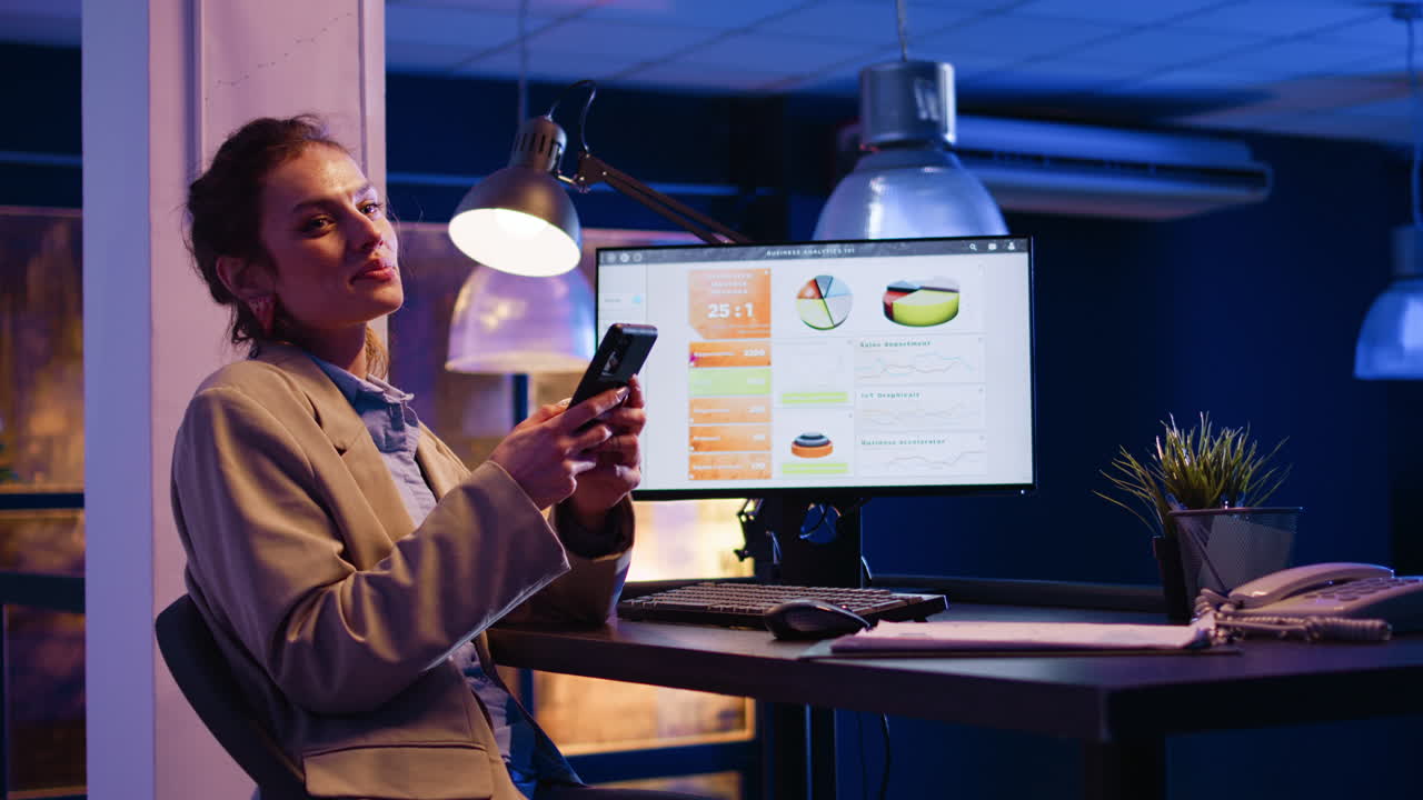 Businesswoman working in the office with analytics on computer screen