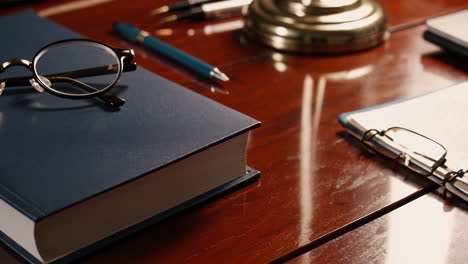 elegant office desk with book and glasses