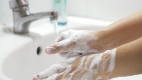 concept of health cleaning and preventing from coronavirus or covid-19 pandemic prevention wash hands with soap and warm water rubbing fingers washing frequently or using hand sanitizer gel