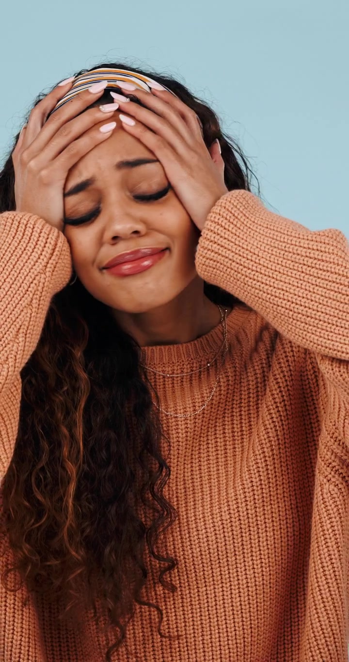 Stressed Young Woman Holding Her Head in Frustration