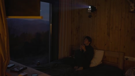 A person relaxing in a cozy room at night