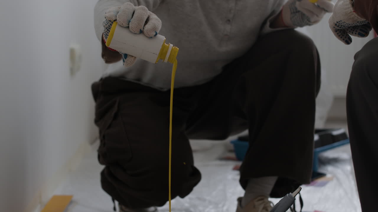 Two People Mixing Paint for Home Improvement Project