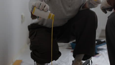 two people mixing paint for home improvement project