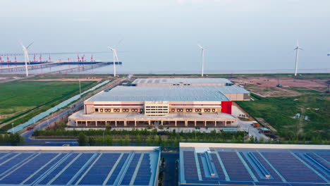 aerial shot of new distribution warehouse panning up to show blue sky