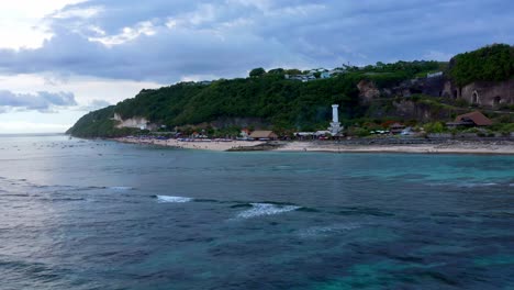 pandawa beach and lighthouse in bali, indonesia - aerial drone shot