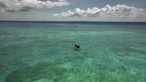people kayaking in crystal clear tropical waters