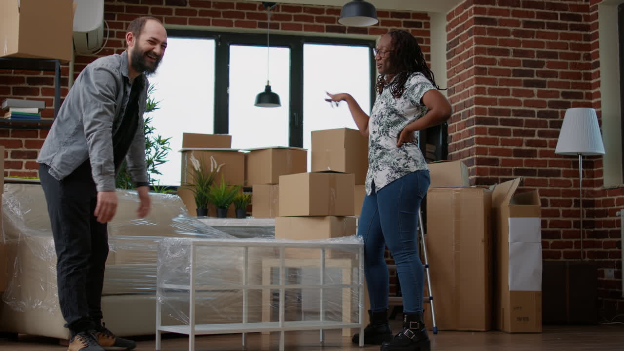 Homeowners couple decorating apartment flat with furniture after moving in