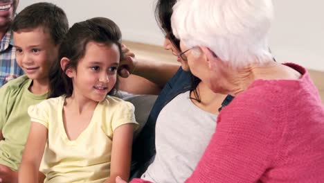 Linda-Familia-Multigeneracional-Hablando-En-El-Sofá