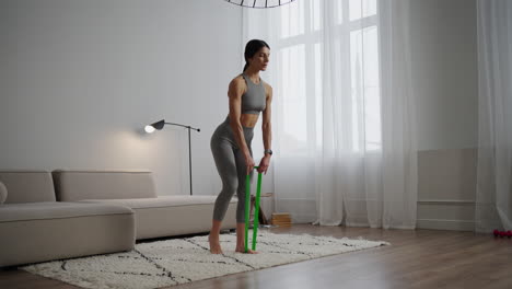 mujer haciendo entrenamiento de banda de resistencia en casa