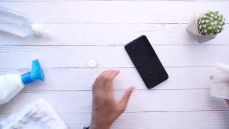 cleaning a smartphone with disinfectant wipes