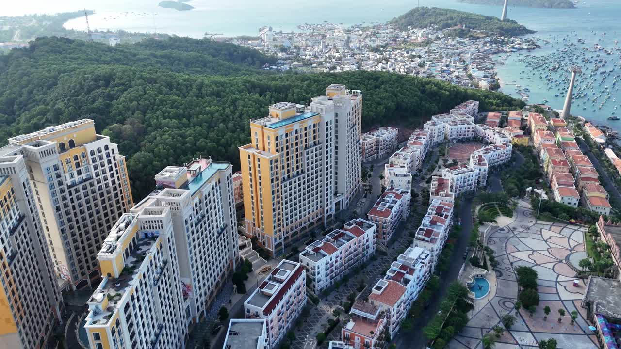 Aerial footage of Phu Quoc Island, Vietnam, shows highrise buildings with infinity swimming pools. Beautiful Mediterranean architecture, and the coast with a variety of boats and elegant yachts