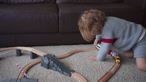 little boy playing with toy track