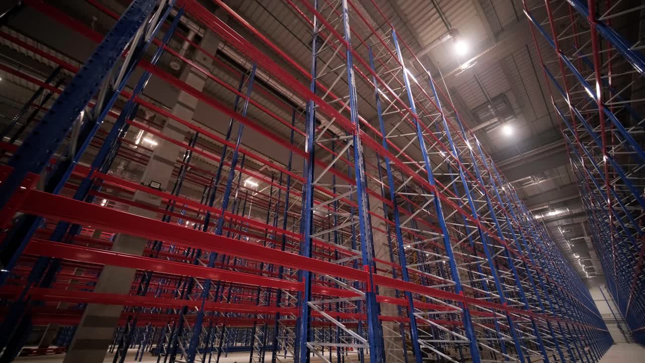 gran y moderno almacén en construcción, con estanterías metálicas y otros equipos industriales.