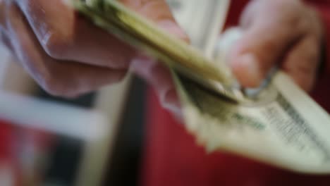 Human-hands-counting-dollar-bills.-Close-up-of-hands-count-money-cash