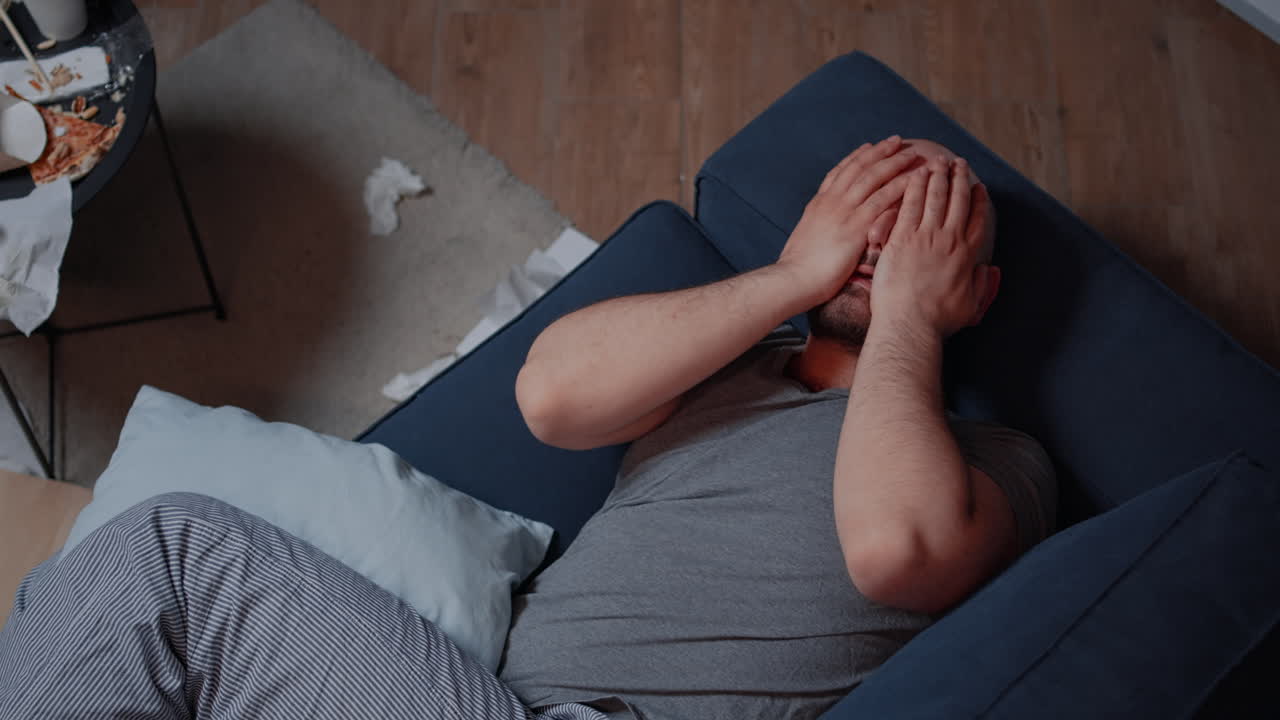 Traumatized adult man finding news that makes to fall into desperation