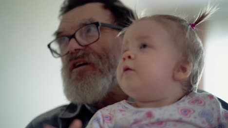 grandfather with a beard wearing glasses playing