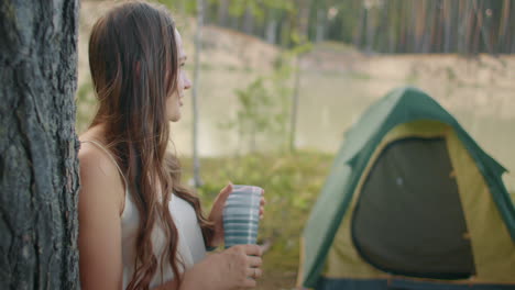 adult joyful woman and her cute little son in tent camping in forest campers and tourists