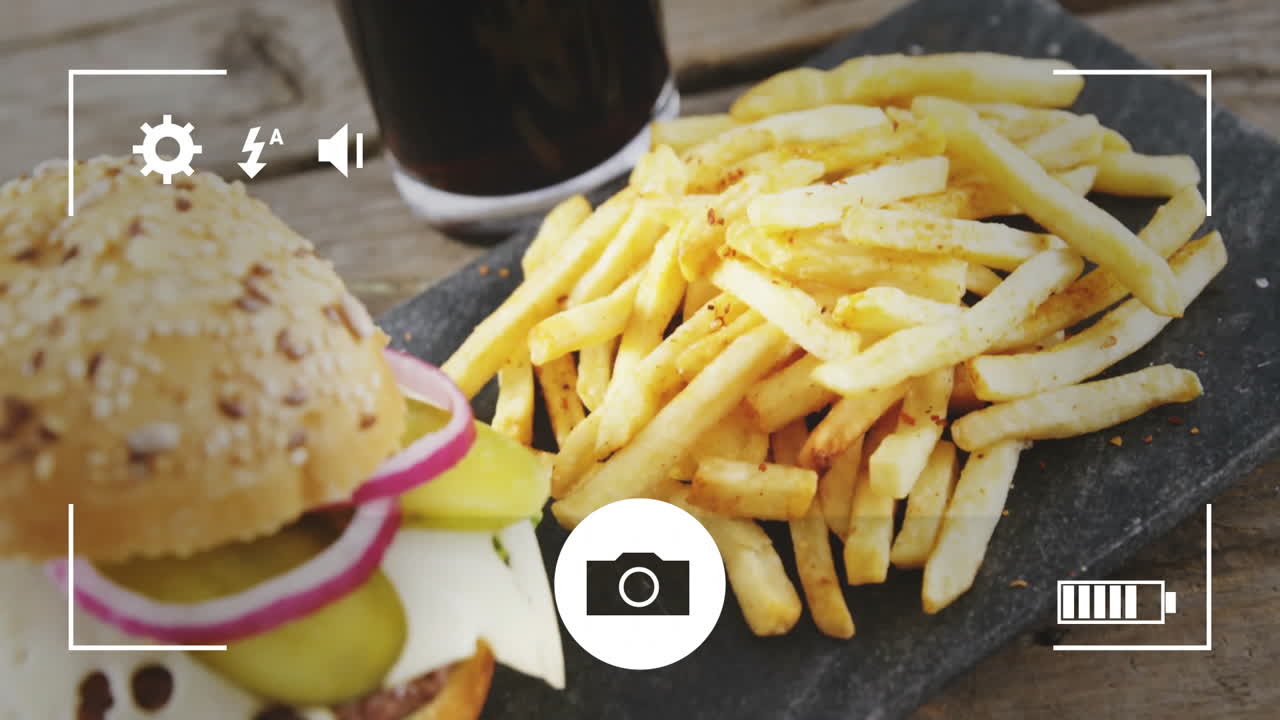 French fries and drink on table with camera settings animation overlay