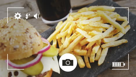 french fries and drink on table with camera settings animation overlay