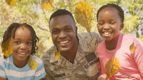 animation of leaves falling over happy african american soldier father and kids