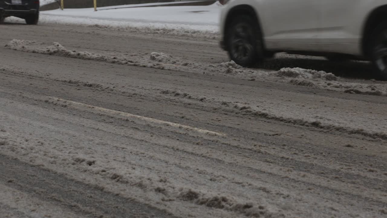 A Snowy, Muddy Road On A Cold Winter Day - Tilt Down Shot