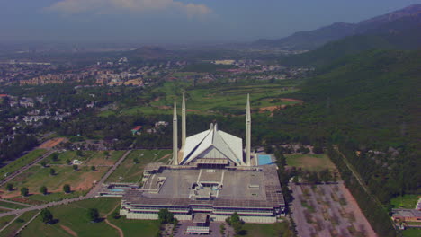 aerial view of faisal mosque with city, located on the foothills of margalla hills in islamabad, pakistan