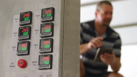 male worker using digital tablet in distillery 4k