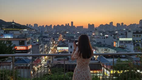 capturing the serene beauty of the cityscape at dusk: a solo photographer enjoys the vibrant horizon as the day transitions to night