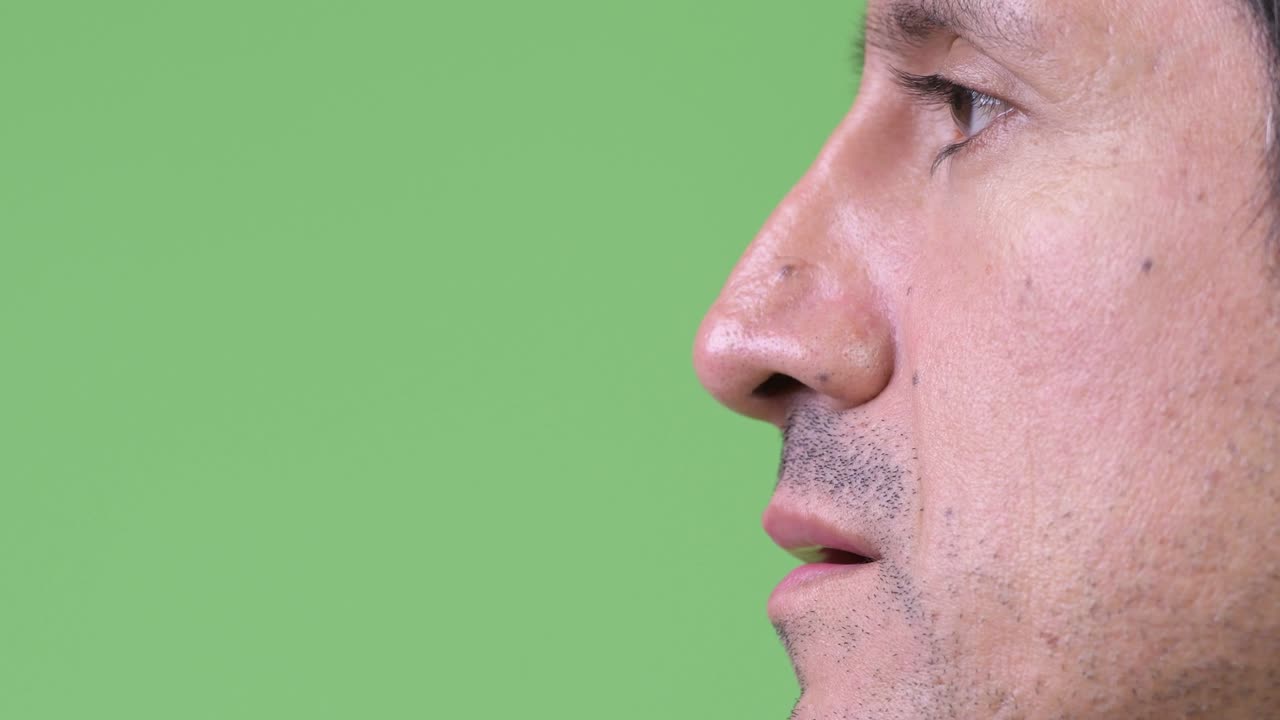 Close-up side view of Hispanic man